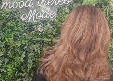 Elegant hairstyle at Hair By Suzannee, set against lush greenery in Heswall, England, GB.