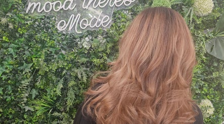 Elegant hairstyle at Hair By Suzannee, set against lush greenery in Heswall, England, GB.