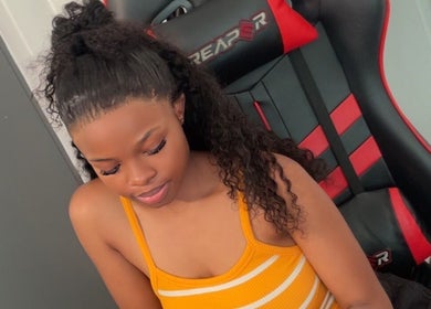 Woman seated, styled hair at SlayedbyNikita, Cape Town, Western Cape, ZA.
