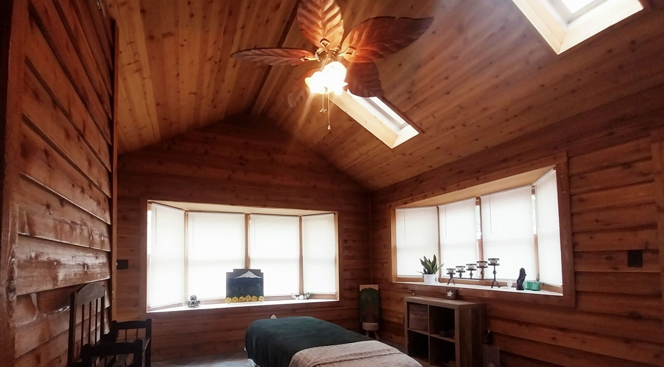 Cozy massage room at Book the Massage, featuring wooden interiors and soft lighting in Montgomery, Alabama, US.