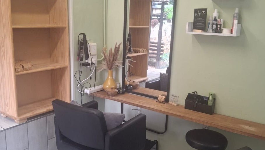 Modern styling station at Flow By Ane, Pretoria, Gauteng, ZA featuring a sleek black chair and essential products.