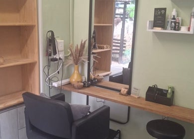 Modern styling station at Flow By Ane, Pretoria, Gauteng, ZA featuring a sleek black chair and essential products.