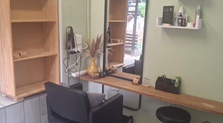Modern styling station at Flow By Ane, Pretoria, Gauteng, ZA featuring a sleek black chair and essential products.