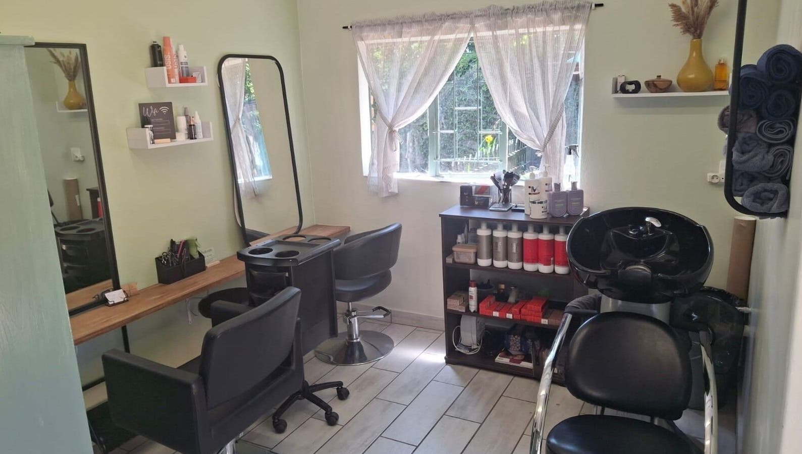 Modern hair salon interior at Flow By Ane, Pretoria, Gauteng, ZA, featuring styling and washing stations.