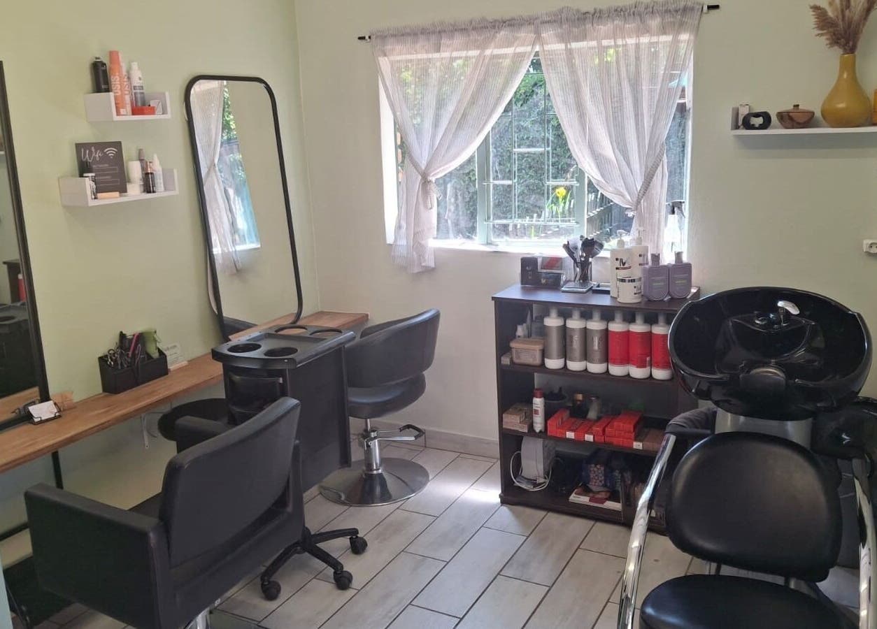 Modern hair salon interior at Flow By Ane, Pretoria, Gauteng, ZA, featuring styling and washing stations.