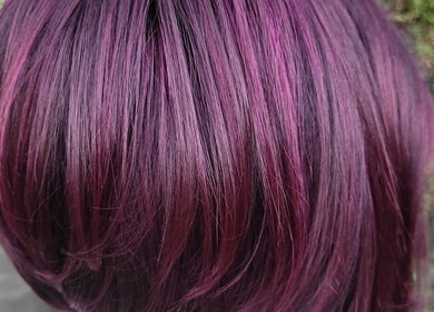 Vivid purple hair color styled at Flow By Ane in Pretoria, Gauteng, ZA, showcasing a modern look.