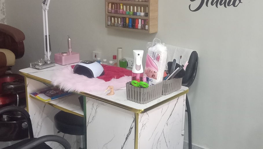 Nail care station at The Point Haircut & Spa, Accra, Greater Accra Region, GH, showcasing equipment and polishes.