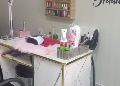 Nail care station at The Point Haircut & Spa, Accra, Greater Accra Region, GH, showcasing equipment and polishes.