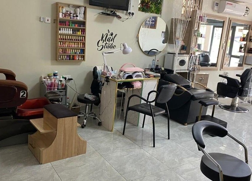 Interior of The Point Haircut & Spa, Accra, showing nail and hair stations.