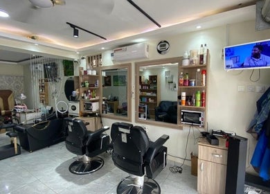 Interior of The Point Haircut & Spa in Accra, Greater Accra Region, GH, featuring modern salon chairs.