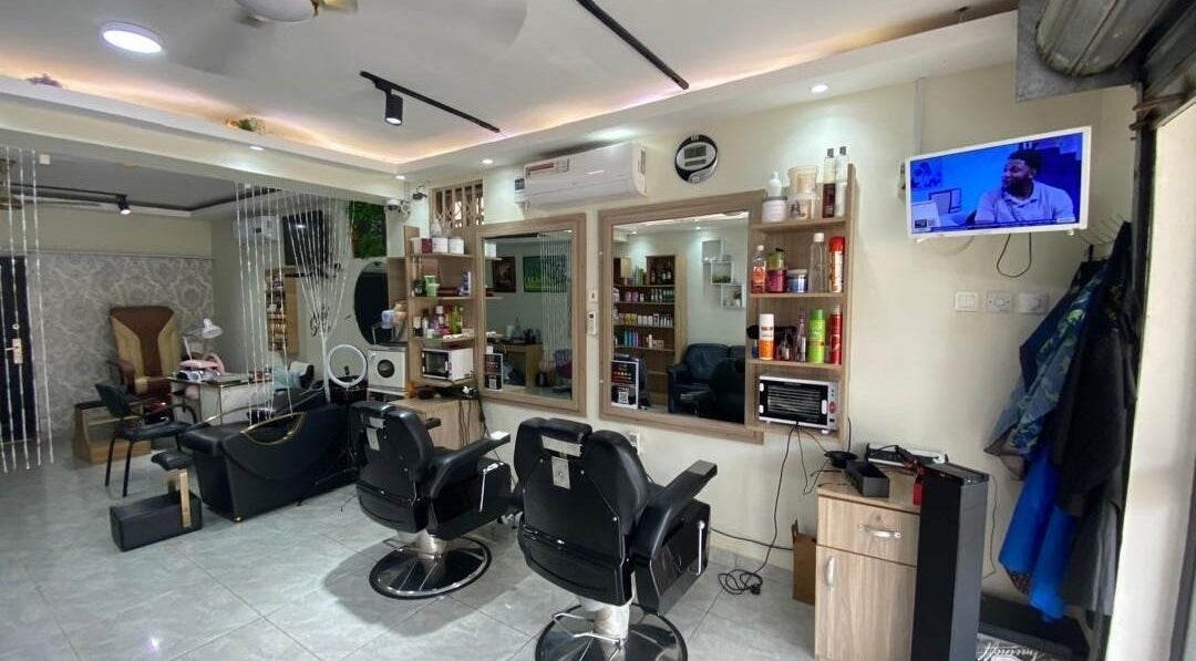 Interior of The Point Haircut & Spa in Accra, Greater Accra Region, GH, featuring modern salon chairs.