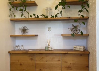 Elegant wooden shelves with decor and plants at Oakland Glow, Oakland, California, US.