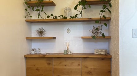 Elegant wooden shelves with decor and plants at Oakland Glow, Oakland, California, US.