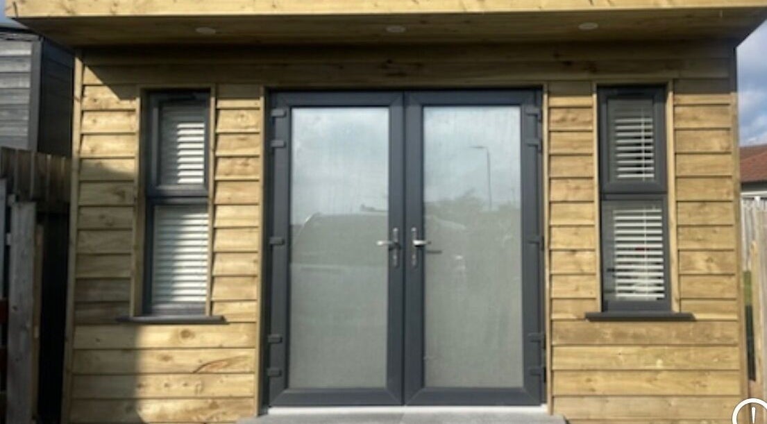 Modern wooden facade of Glow By Olivia, Warrenpoint, Northern Ireland, GB with sleek glass doors.