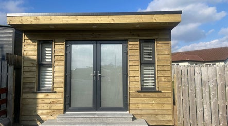Modern wooden exterior of Glow By Olivia, Warrenpoint, Northern Ireland, GB under a clear sky.
