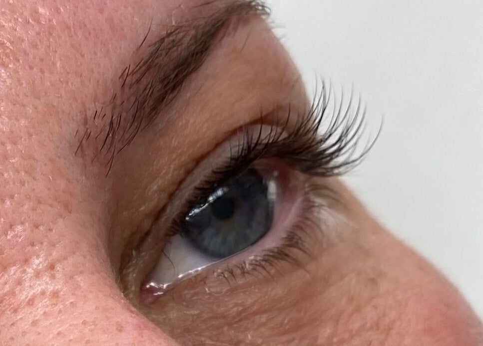Close-up of eye with styled lashes at LashandBe, London, England, GB. Enhancing natural beauty.