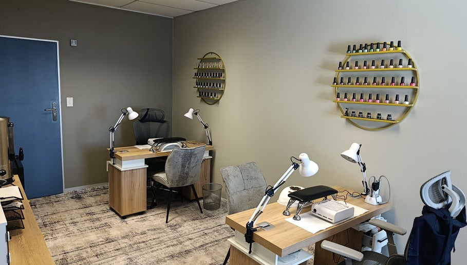 Modern nail station at Coco Beauty Co. in Pretoria, Gauteng, ZA with polishes displayed on a stylish shelf.