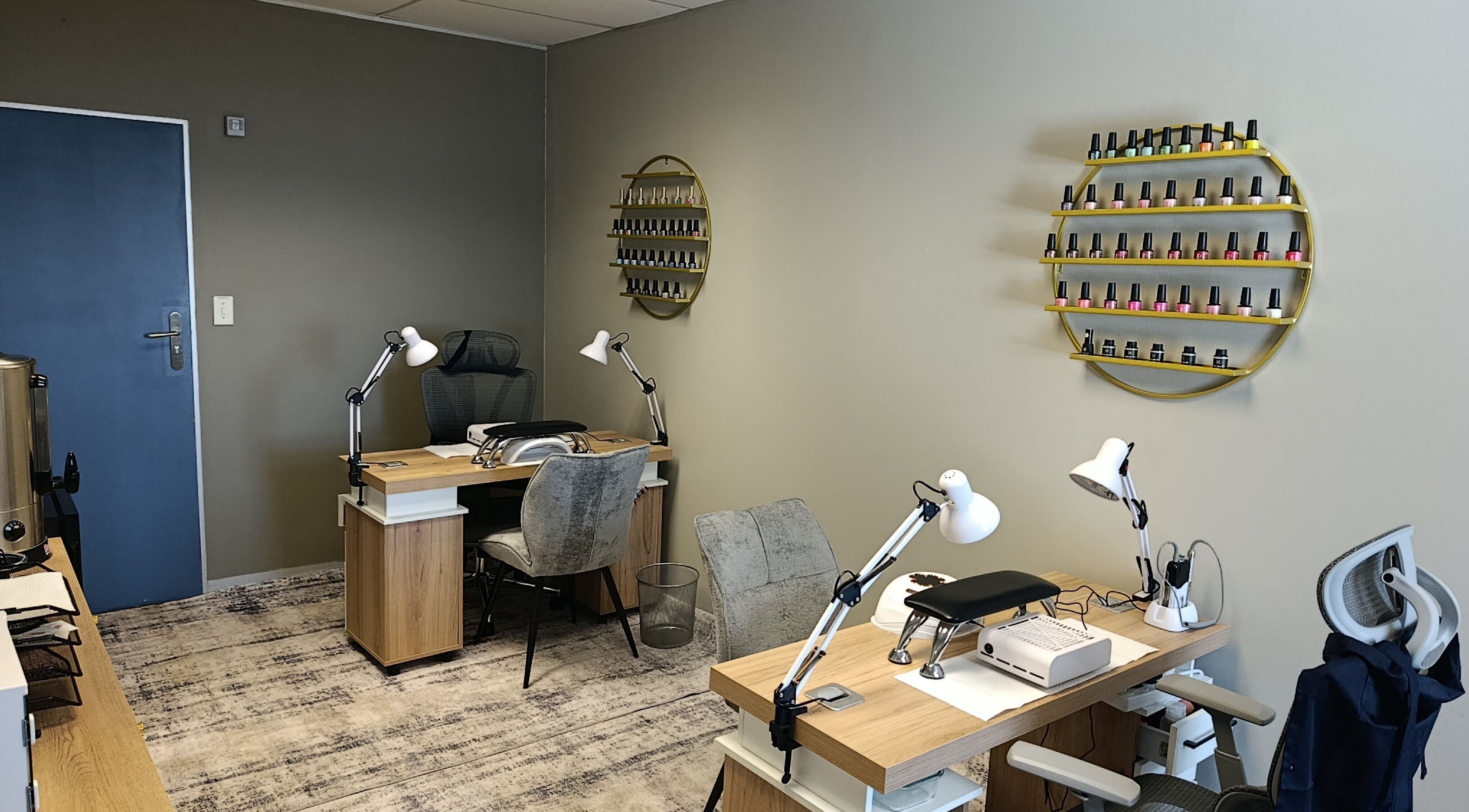 Modern nail station at Coco Beauty Co. in Pretoria, Gauteng, ZA with polishes displayed on a stylish shelf.