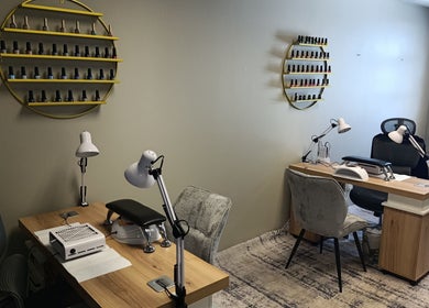 Modern nail salon setup at Coco Beauty Co., Pretoria, Gauteng, ZA with stylish seating and nail polish display.