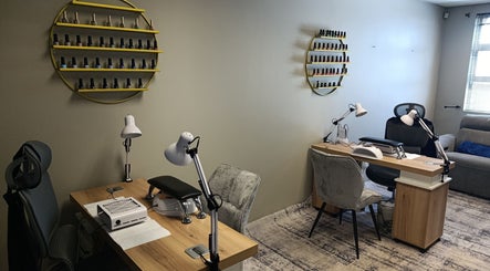 Modern nail salon setup at Coco Beauty Co., Pretoria, Gauteng, ZA with stylish seating and nail polish display.