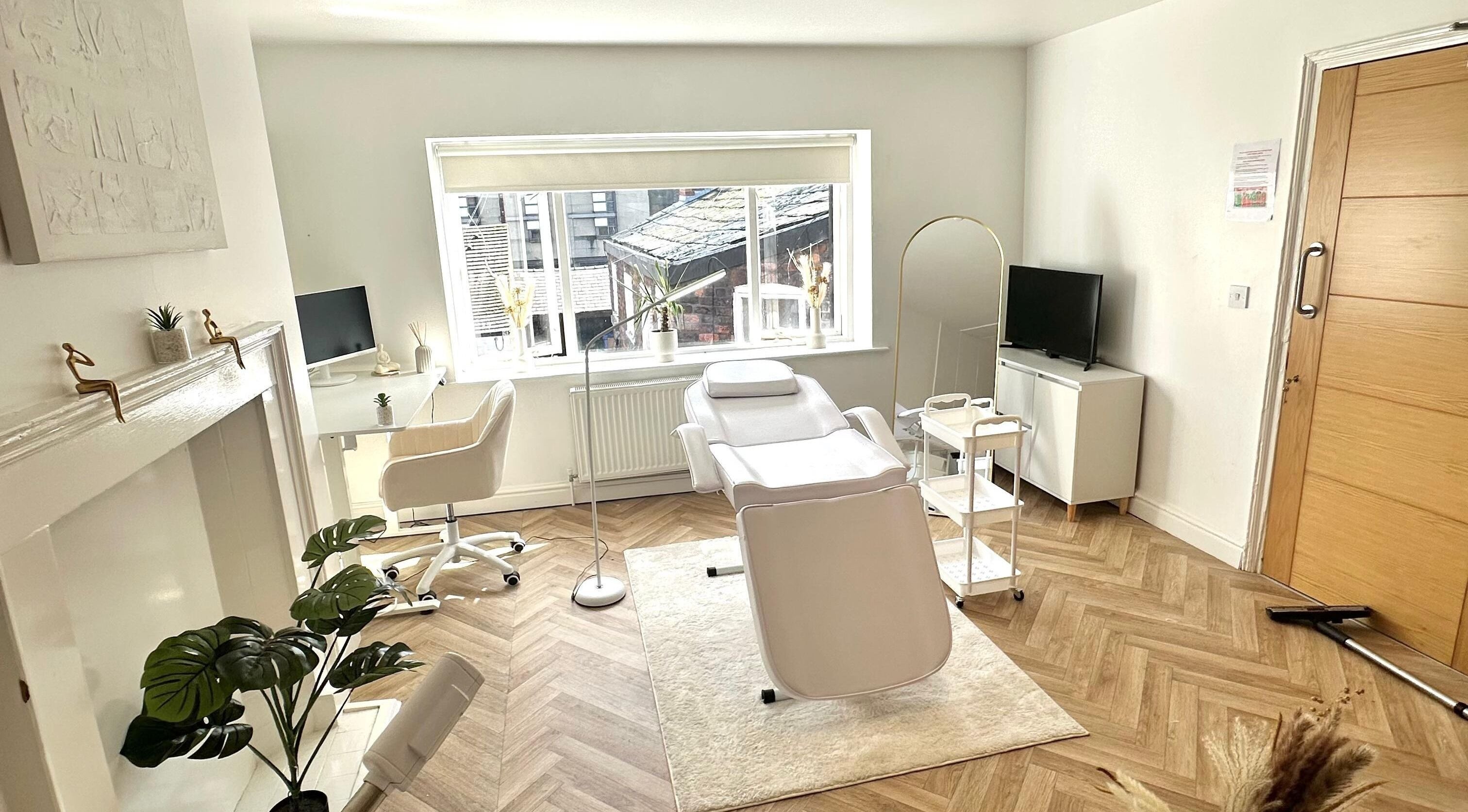 Modern treatment room at Skin and Snatch Studio, Liverpool, England, GB, with chic decor and comfortable seating.