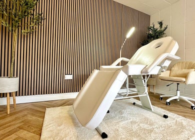 Elegant treatment room at Skin and Snatch Studio, Liverpool, England, GB with a sleek chair and modern decor.