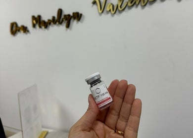 Close-up of hand holding serum vial at Sueroterapia Medellín, Medellín, Antioquia, CO.