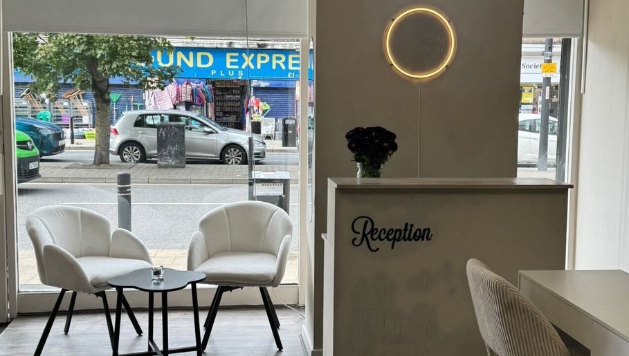 Stylish reception area of Noa Beauty in Wythenshawe, England, GB with chic chairs and modern decor.