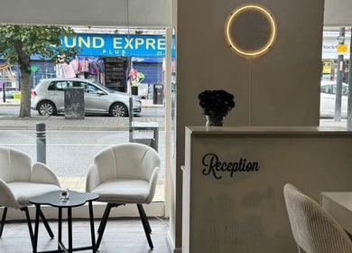 Stylish reception area of Noa Beauty in Wythenshawe, England, GB with chic chairs and modern decor.