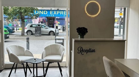 Stylish reception area of Noa Beauty in Wythenshawe, England, GB with chic chairs and modern decor.