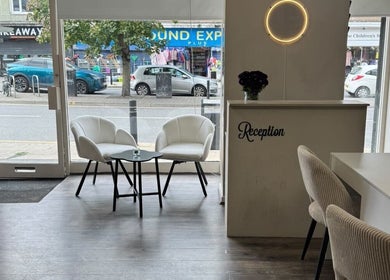 Chic reception area at Noa Beauty, Wythenshawe, England, GB with modern decor and stylish seating.