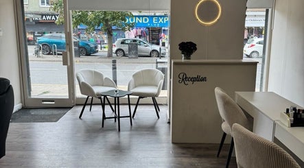 Chic reception area at Noa Beauty, Wythenshawe, England, GB with modern decor and stylish seating.