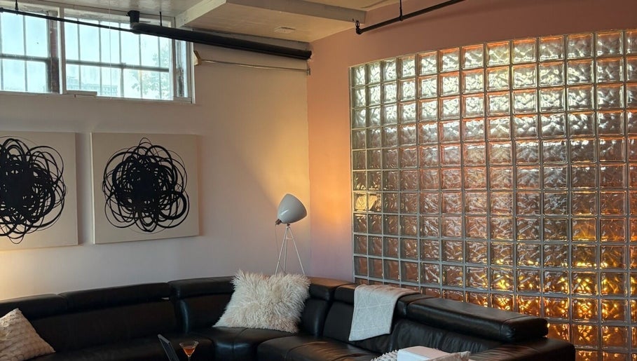 Modern lounge with art and glass wall at Quel Studio 🎀 in Montréal, Québec, CA.