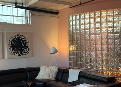 Modern lounge with art and glass wall at Quel Studio 🎀 in Montréal, Québec, CA.