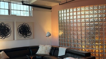 Modern lounge with art and glass wall at Quel Studio 🎀 in Montréal, Québec, CA.