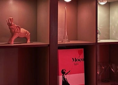 Stylish shelf decor at Quel Studio 🎀, Montréal, Québec, CA. Features a pink elephant and graphic art.