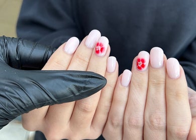 Elegant nail art featuring red flowers by Prepped by Emily in Scarborough, England, GB.