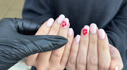 Elegant nail art featuring red flowers by Prepped by Emily in Scarborough, England, GB.