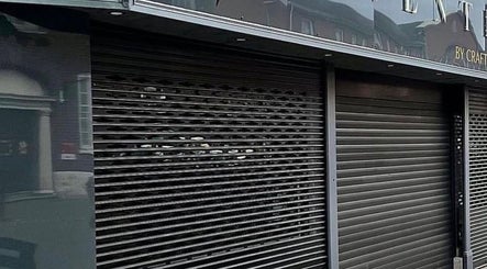 Exterior view of Beauty by Chloe in Strabane, Northern Ireland, GB, featuring sleek metal shutters.