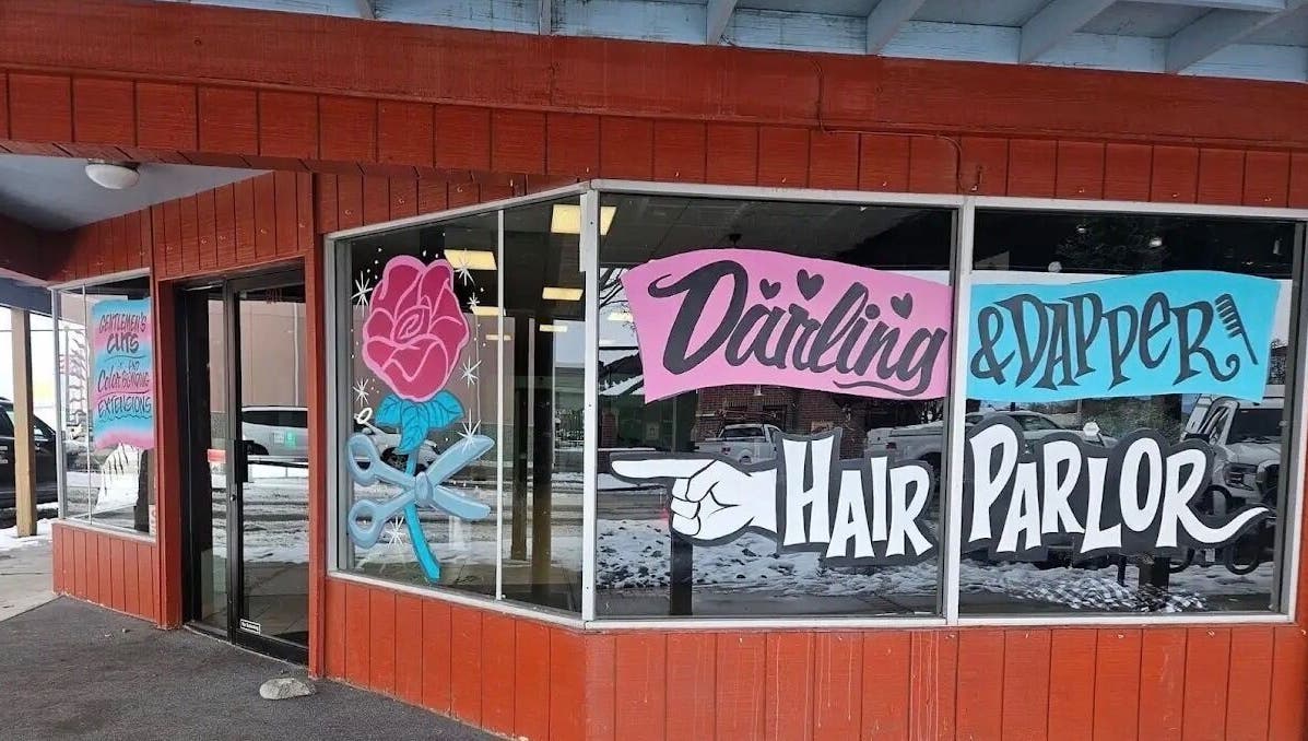 Tahnisha @ Darling & Dapper salon exterior in Fallon, Nevada, US with colorful window art and signage.