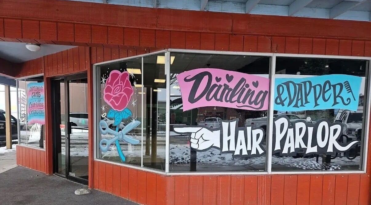 Tahnisha @ Darling & Dapper salon exterior in Fallon, Nevada, US with colorful window art and signage.