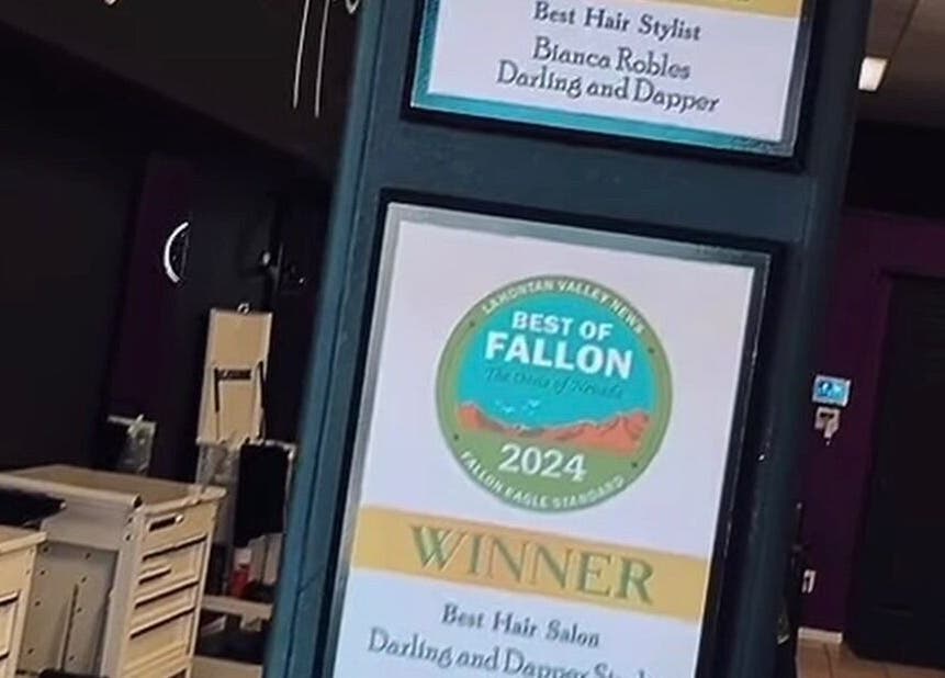 Award plaques displayed at Tahnisha @ Darling & Dapper, Fallon, Nevada, US, honoring the salon's excellence.