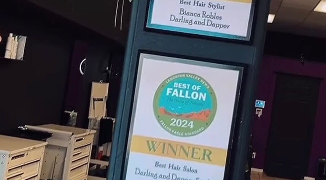 Award plaques displayed at Tahnisha @ Darling & Dapper, Fallon, Nevada, US, honoring the salon's excellence.