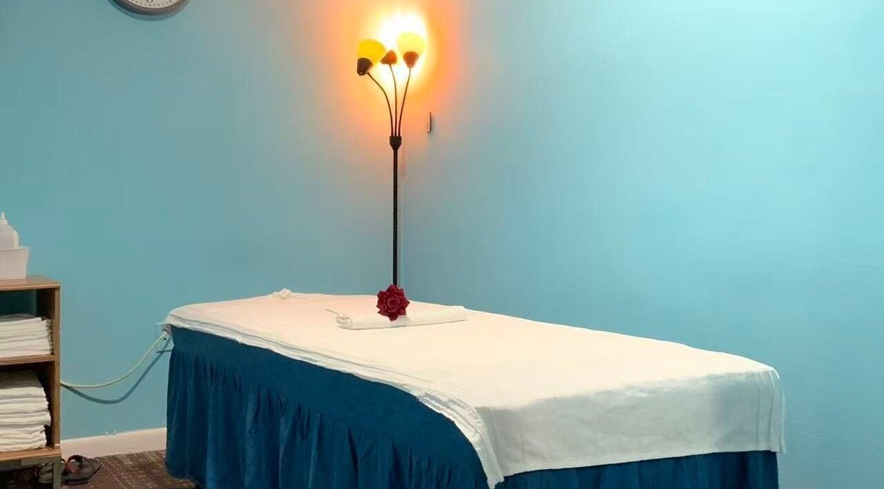 Tranquil massage room at Wellness Foot Spa in Glenside, Pennsylvania, US with cozy lighting.