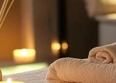 Relaxing setting at Lumina Massage Wellness Center in Markham, Ontario, CA with candles and towels.