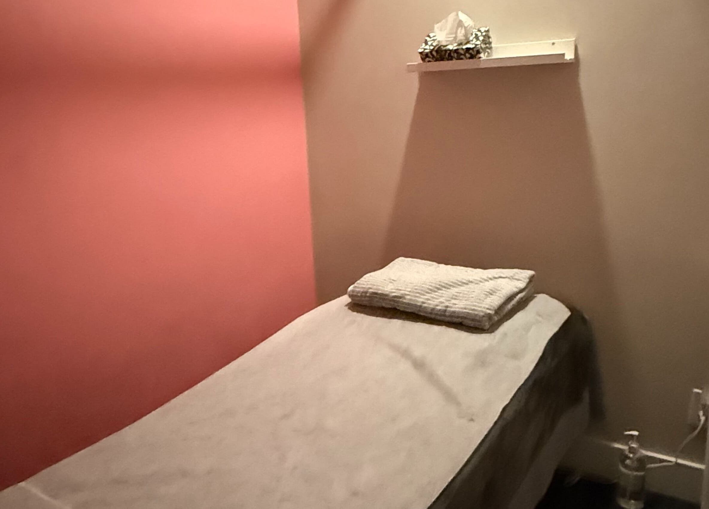 Cozy massage room at Lumina Massage Wellness Center, Markham, Ontario, CA with soft lighting and a comfortable table.