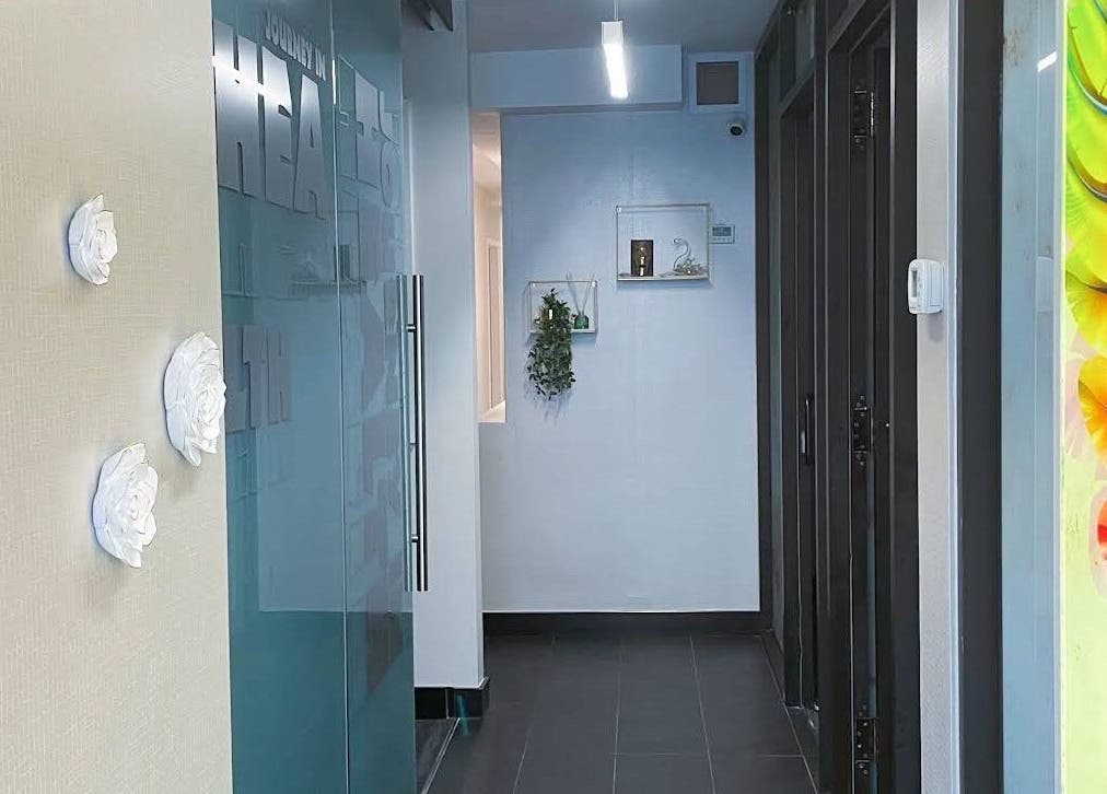 Bright hallway in Lumina Massage Wellness Center, Markham, Ontario, CA with floral and vibrant decor.