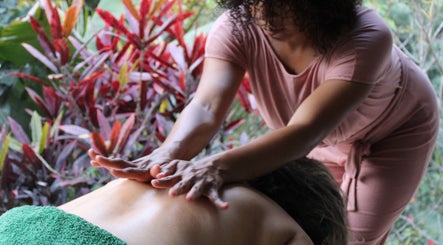 Relaxing massage session at Meraki massage by Haidelyn Cordoba in Frome, GB with lush plant backdrop.