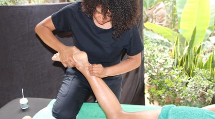Foot massage at Meraki massage by Haidelyn Cordoba in lush garden setting, Frome, GB.