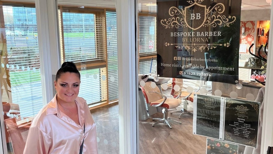 Woman smiling at Bespoke Barber by Lorna entrance in Wythenshawe, England, GB.